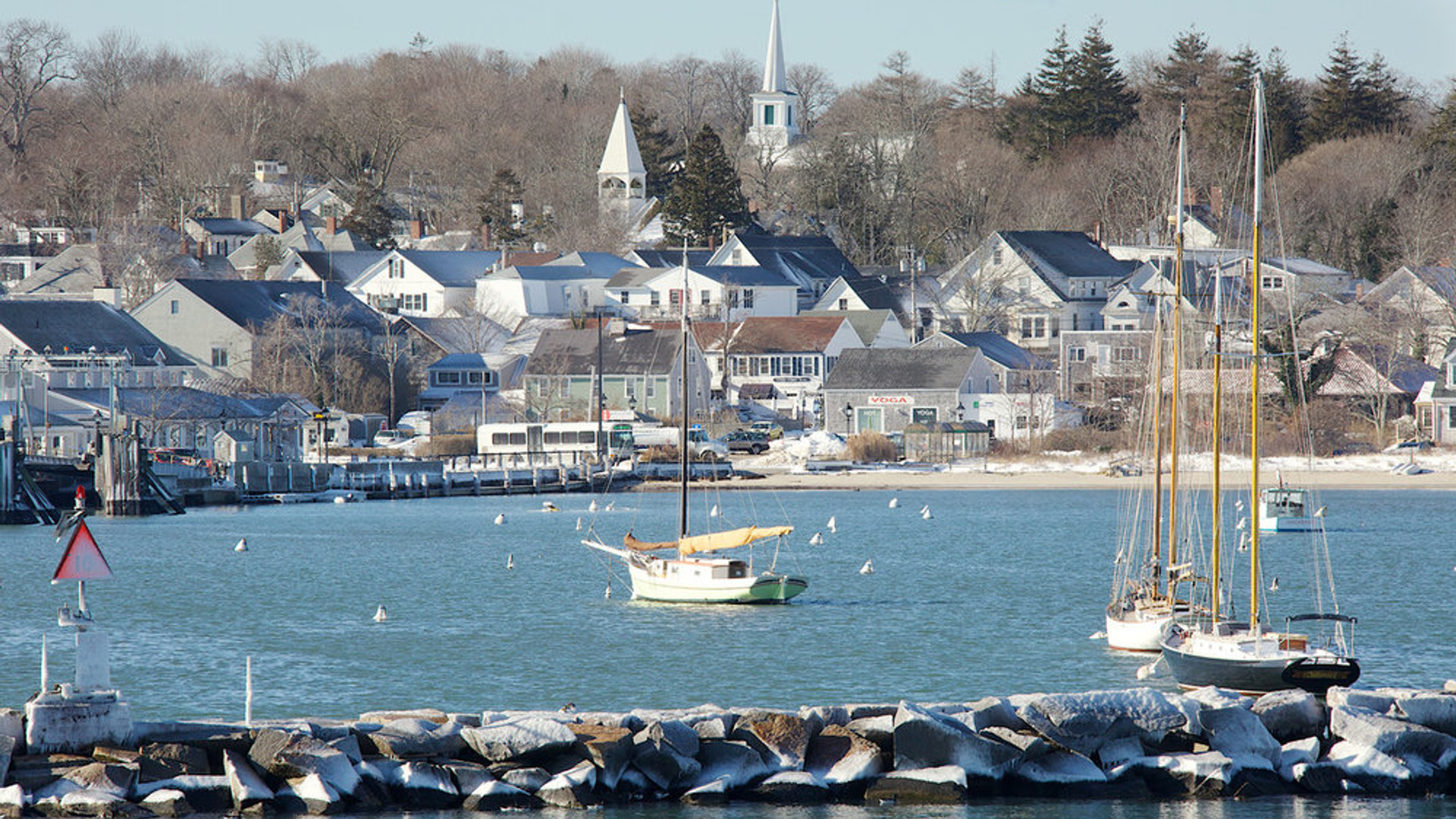 Harbor view of a Cape Cod village with sailboats